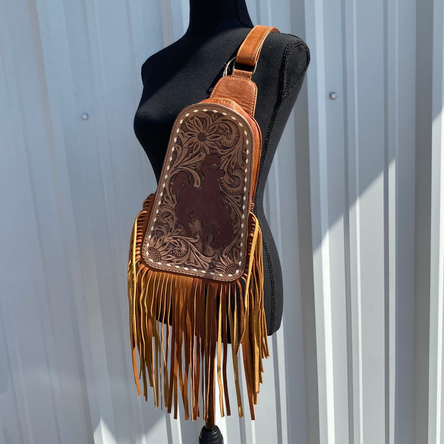 Tooled leather bag with Bronc rider sling