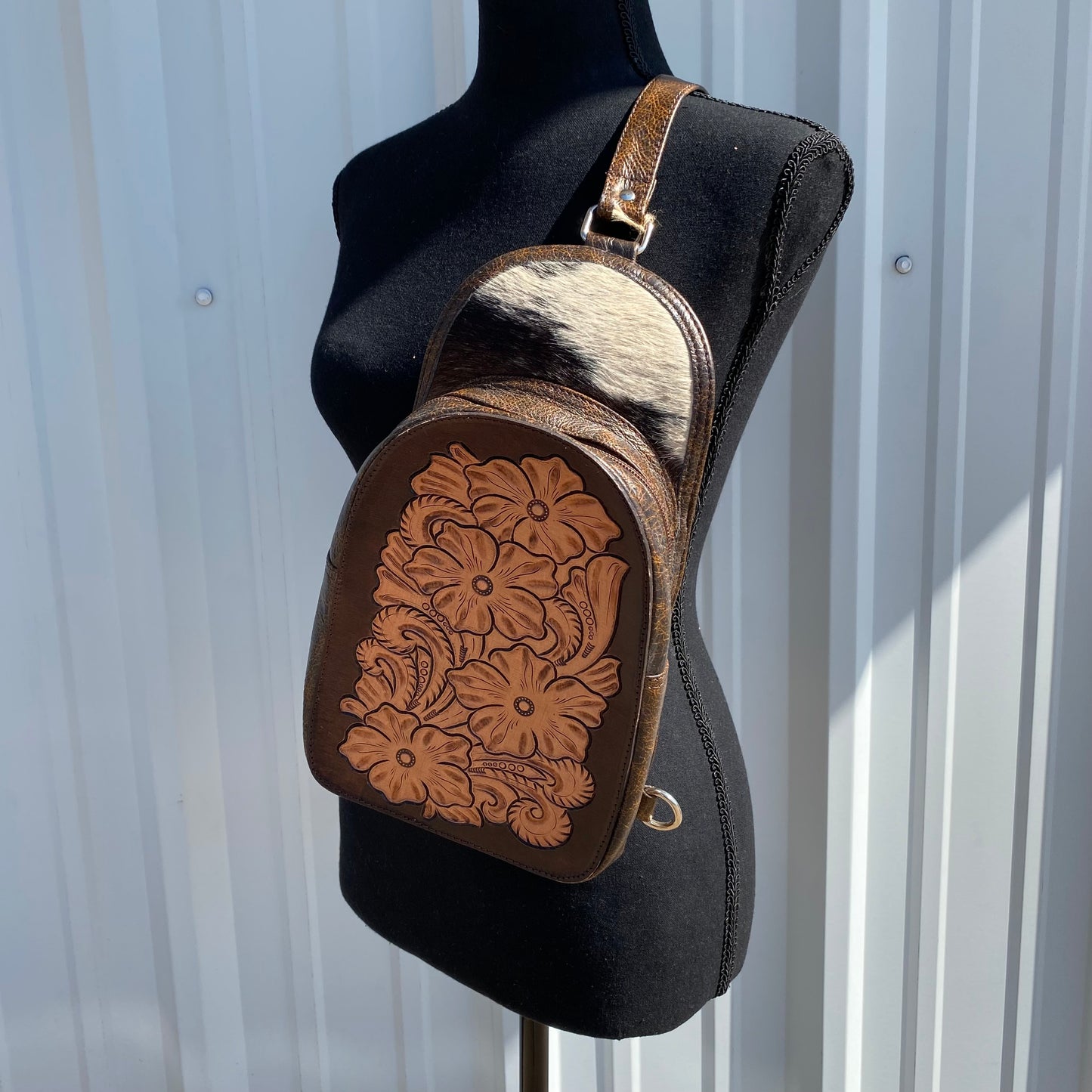 Dark brown bag with tooled leather and cowhide